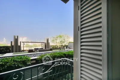 Luxurious balcony with stunning city view and lush greenery, perfect for relaxation and entertainment.