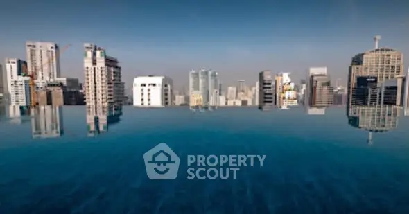 Stunning rooftop infinity pool with breathtaking city skyline view, perfect for luxury urban living.