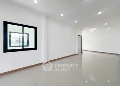 Spacious modern interior with sleek tile flooring and ample natural light, perfect for customization.