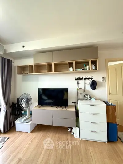 Modern living room with sleek storage, TV, and stylish decor