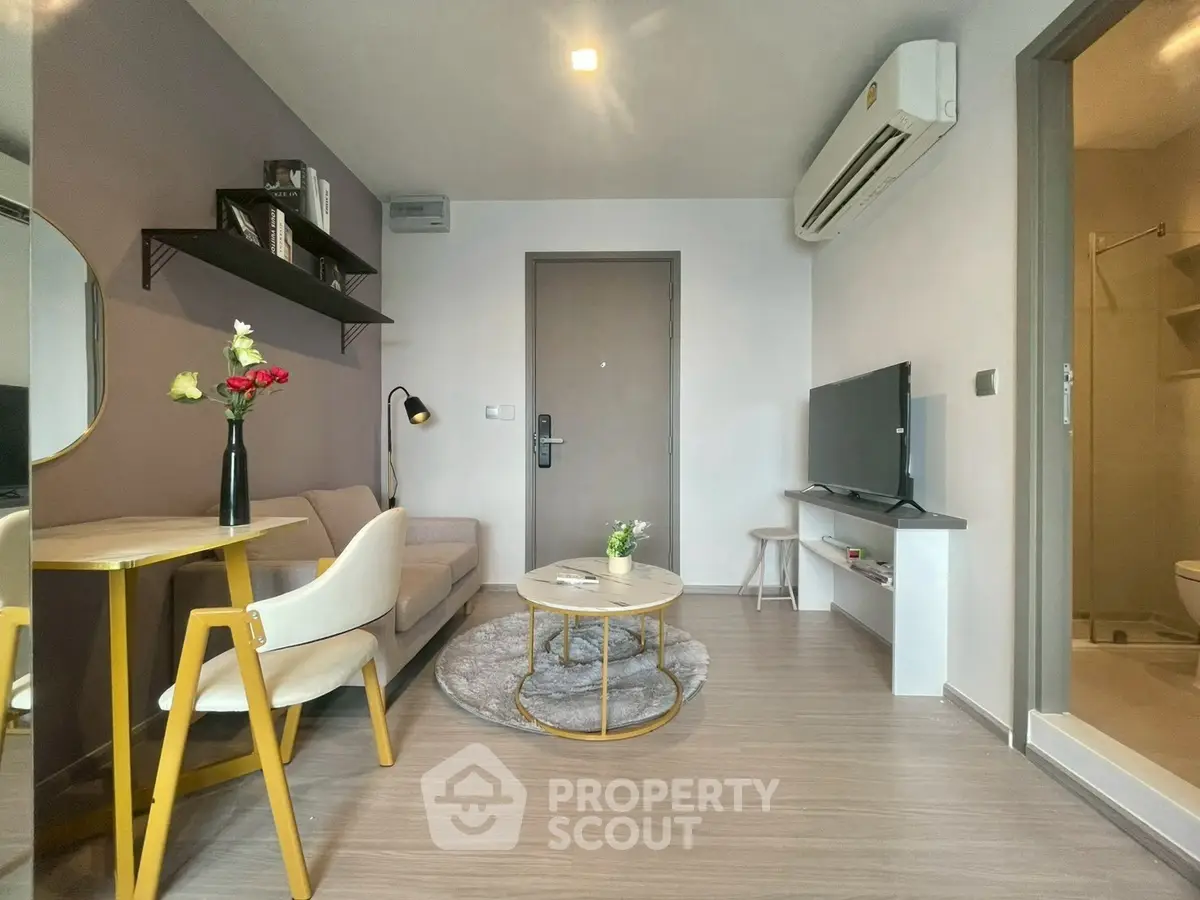 Modern living room with stylish decor and cozy seating area in a contemporary apartment.