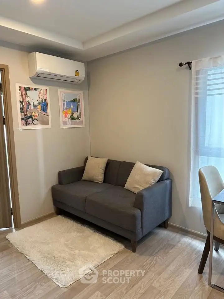Cozy living room with modern gray sofa and stylish decor in a bright apartment.