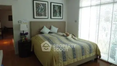 Cozy bedroom with large windows and stylish decor in modern apartment