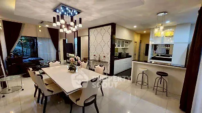 Luxurious open-plan dining and living area with modern lighting and elegant decor.