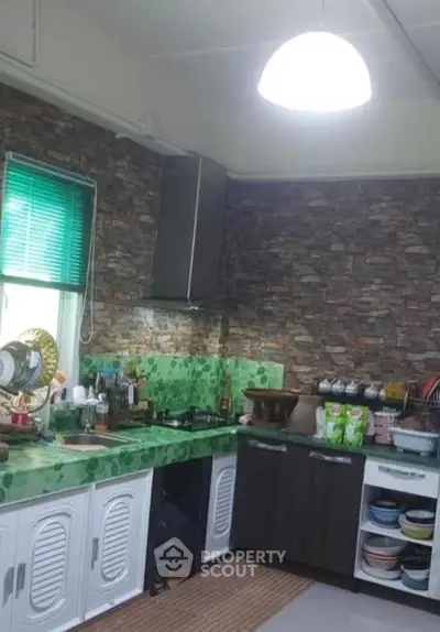 Charming kitchen with stone backsplash and vibrant green countertops.