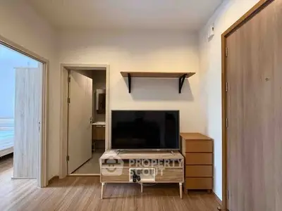 Modern living room with sleek TV stand and wooden flooring