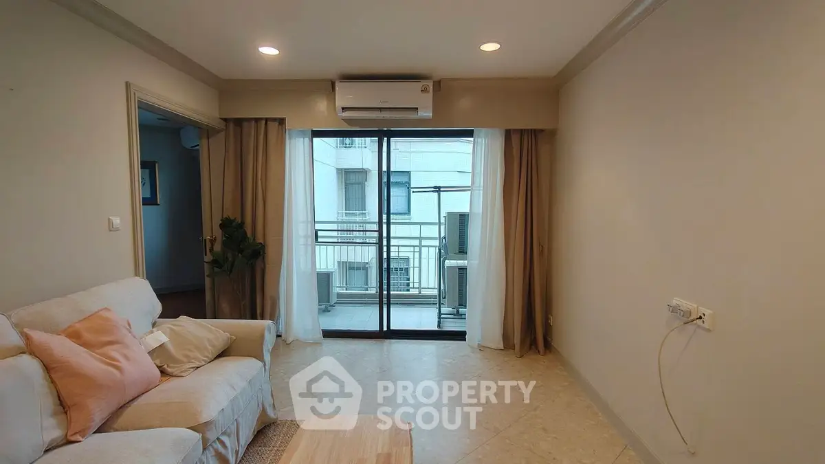 Cozy living room with balcony access in modern apartment