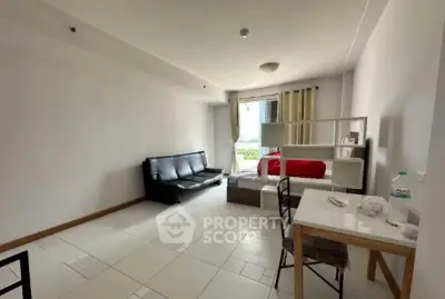 Spacious modern living room with sleek furniture and ample natural light.