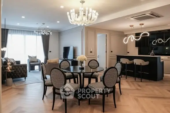 Luxurious open-plan living and dining area with elegant furnishings and modern lighting.