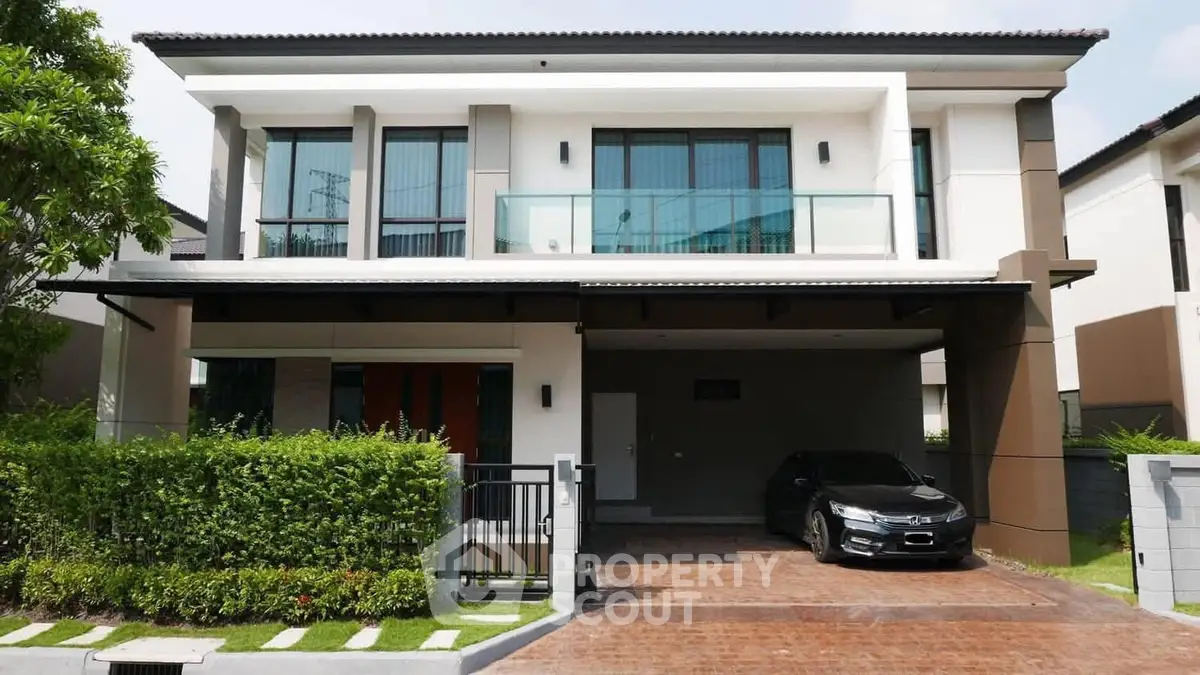 Modern two-story house with sleek design and spacious driveway