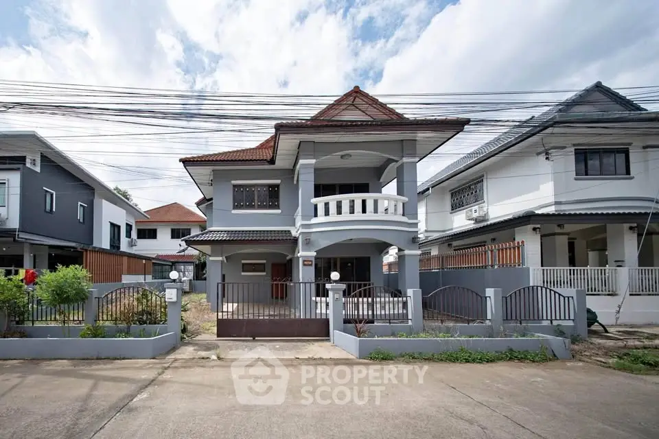 Charming two-story house with unique architectural design and spacious front yard in a serene neighborhood.