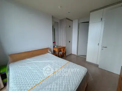 Spacious bedroom with modern furniture and ample storage space