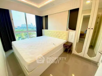Bright and modern bedroom with city view, featuring a large bed and stylish mirrored wardrobe.