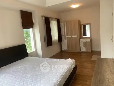Spacious bedroom with modern furniture and natural light