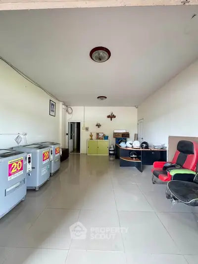 Spacious interior with appliances and seating, ideal for versatile use.