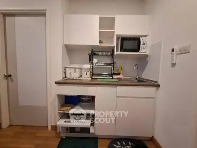 Compact kitchen with modern appliances and efficient storage solutions