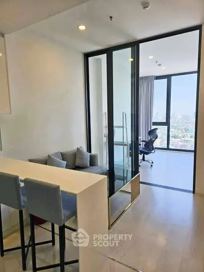 Modern apartment with open layout, featuring a cozy living area and a stunning city view from the balcony.