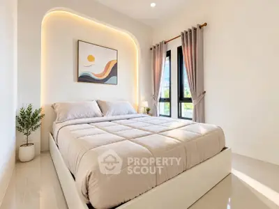 Modern bedroom with elegant decor and natural light, featuring a cozy bed and stylish curtains.