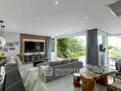 Luxurious open-plan living room with modern decor and stunning garden view