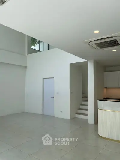 Spacious modern interior with high ceilings and sleek kitchen design
