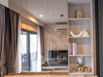 Modern living room with stylish decor and large window offering city views