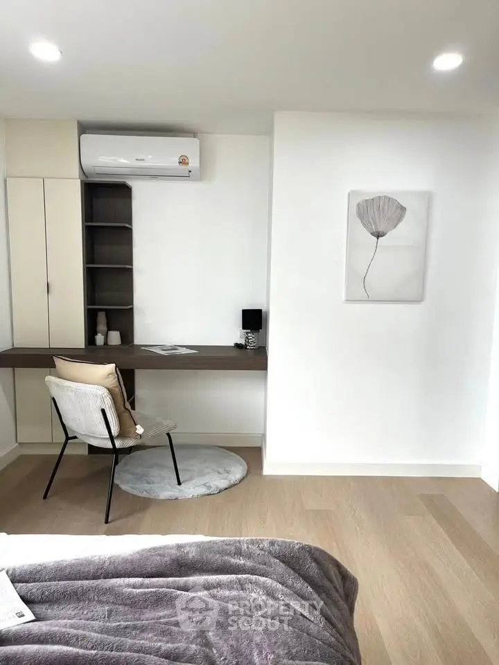 Modern bedroom with stylish study area and air conditioning, perfect for comfort and productivity.