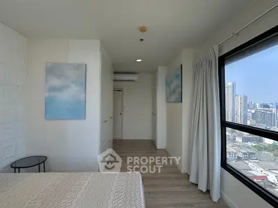 Modern bedroom with city view and stylish decor in high-rise apartment