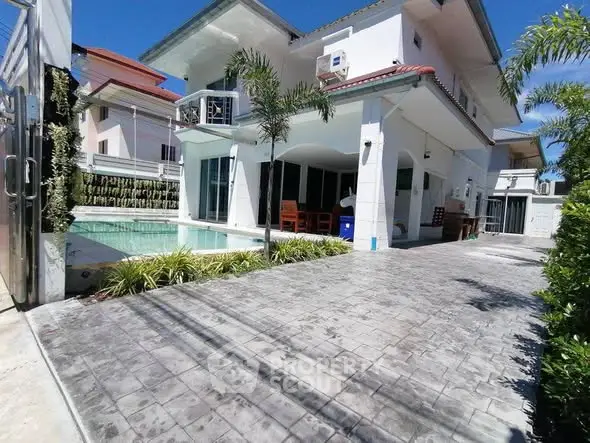 Stunning modern villa with private pool and spacious driveway in a serene neighborhood.