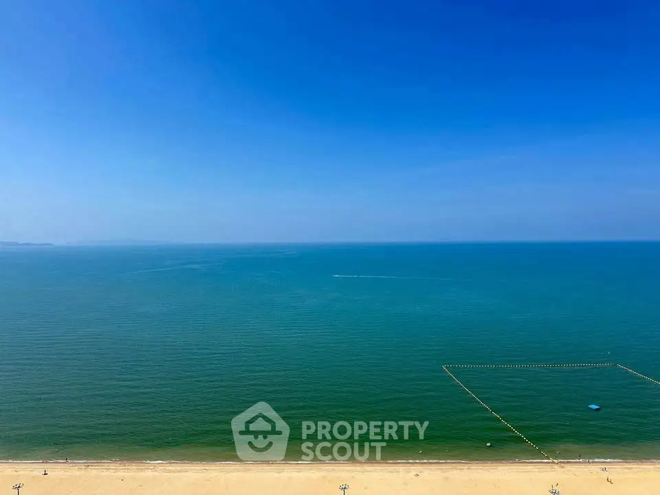 Stunning beachfront view with clear blue skies and serene ocean, perfect for luxury coastal living.