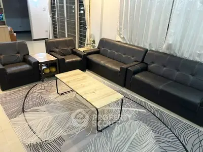 Spacious living room with modern leather sofas and stylish decor