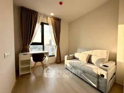 Modern living room with city view, featuring a cozy sofa and stylish desk setup.