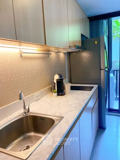 Modern kitchen with sleek cabinetry and stainless steel appliances