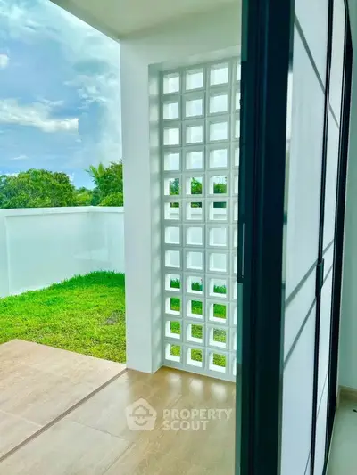 Modern balcony with stylish lattice wall and lush green view