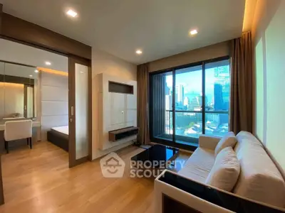 Modern living room with city view, featuring sleek furniture and large windows for natural light.