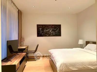 Modern bedroom with elegant decor and natural light, featuring a cozy bed and stylish furniture.