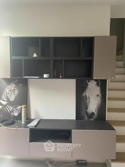 Modern interior with stylish shelving and staircase, featuring unique horse artwork.