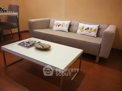 Modern living room with stylish sofa and sleek coffee table in cozy apartment.
