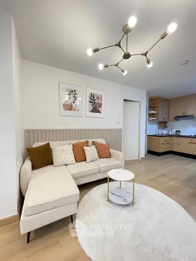 Stylish living room with modern decor and open kitchen layout