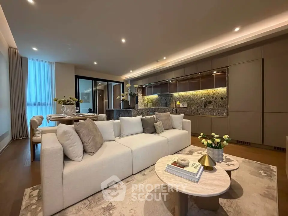 Luxurious open-plan living room with modern kitchen and elegant decor