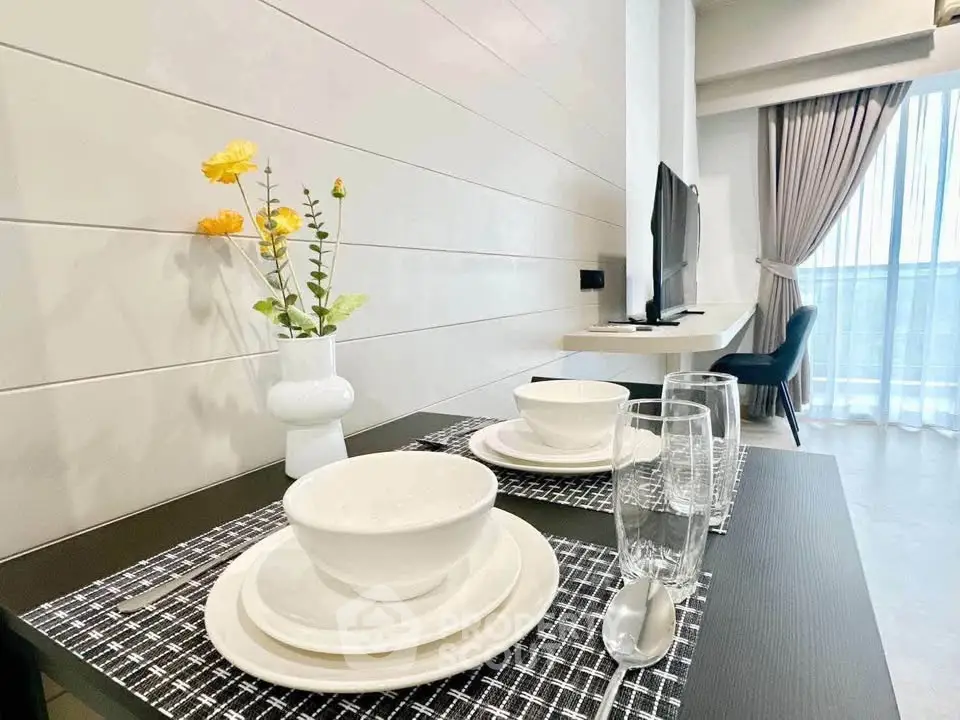 Modern dining area with elegant table setting and bright natural light