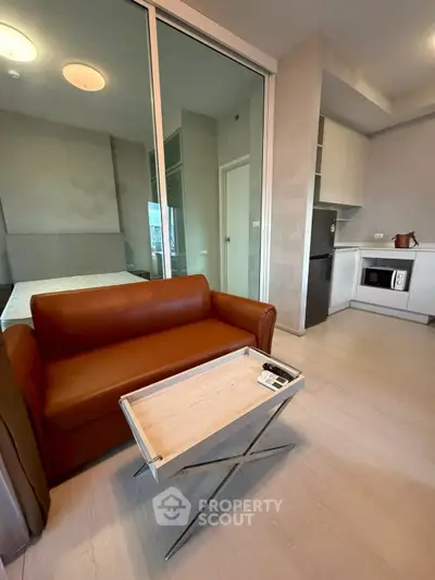 Modern studio apartment with sleek kitchen and cozy living area