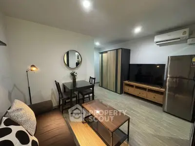 Modern living room with stylish furniture and open layout, featuring a cozy sofa, dining area, and sleek appliances.