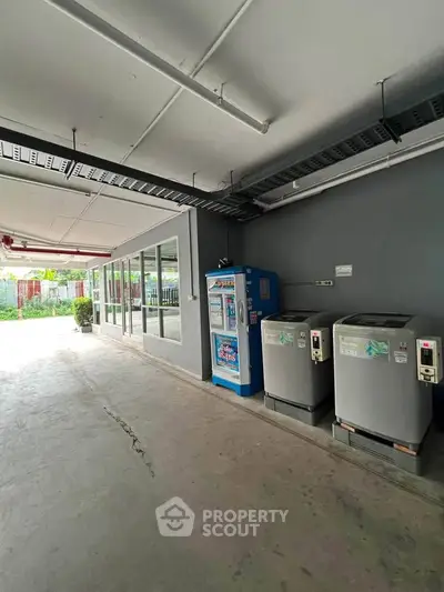 Modern laundry area with vending machine in residential building