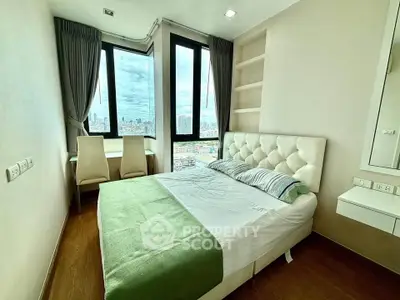 Modern bedroom with city view, featuring a cozy bed and stylish decor in a high-rise apartment.