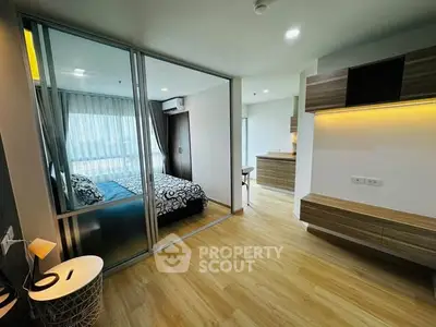 Modern apartment interior with stylish bedroom and open layout kitchen, featuring wooden flooring and sleek design.