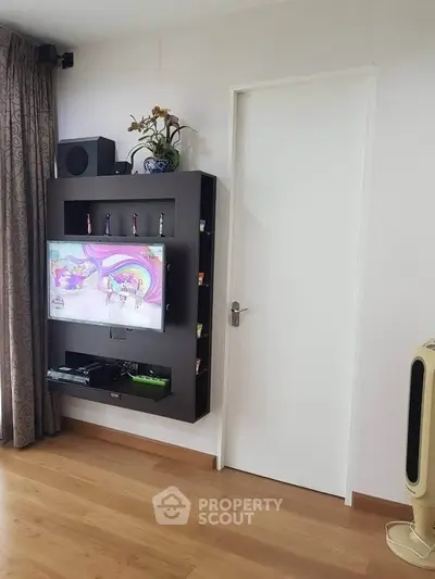 Modern living room with wall-mounted TV and sleek storage unit