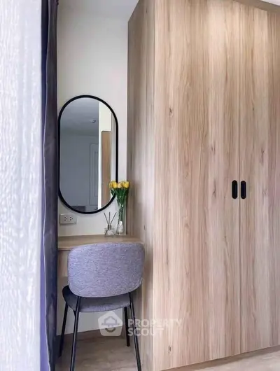 Modern bedroom with stylish wooden wardrobe and elegant vanity setup.