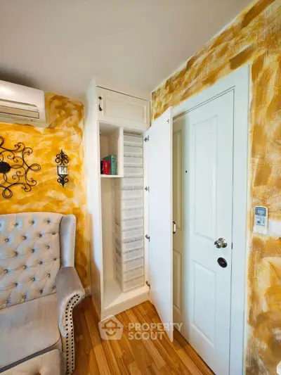 Charming living room with unique wall design and elegant storage solutions.