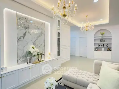 Luxurious living room with elegant chandeliers and marble accent wall