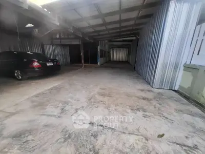 Spacious covered parking area with metal roofing and concrete flooring